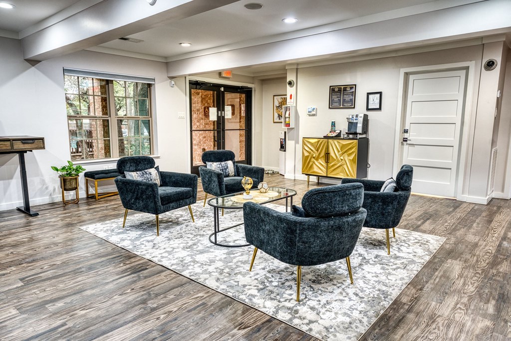 a living room with chairs and a table